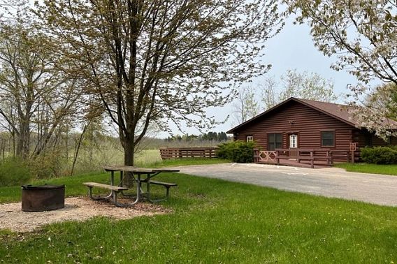 An accessible cabin next to a field at Kohler Andrae State Park.