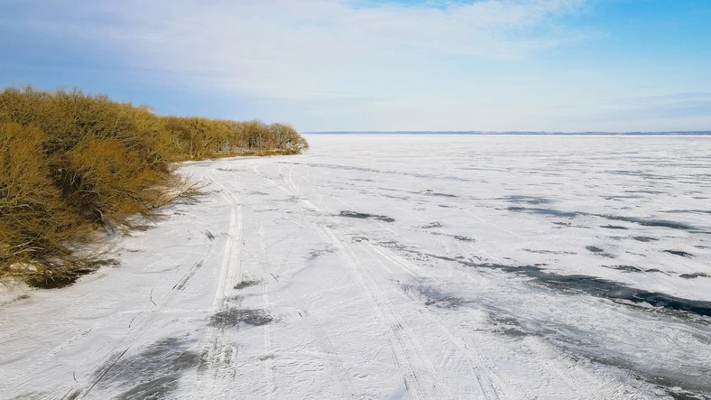 snowmobile trail across frozen lake