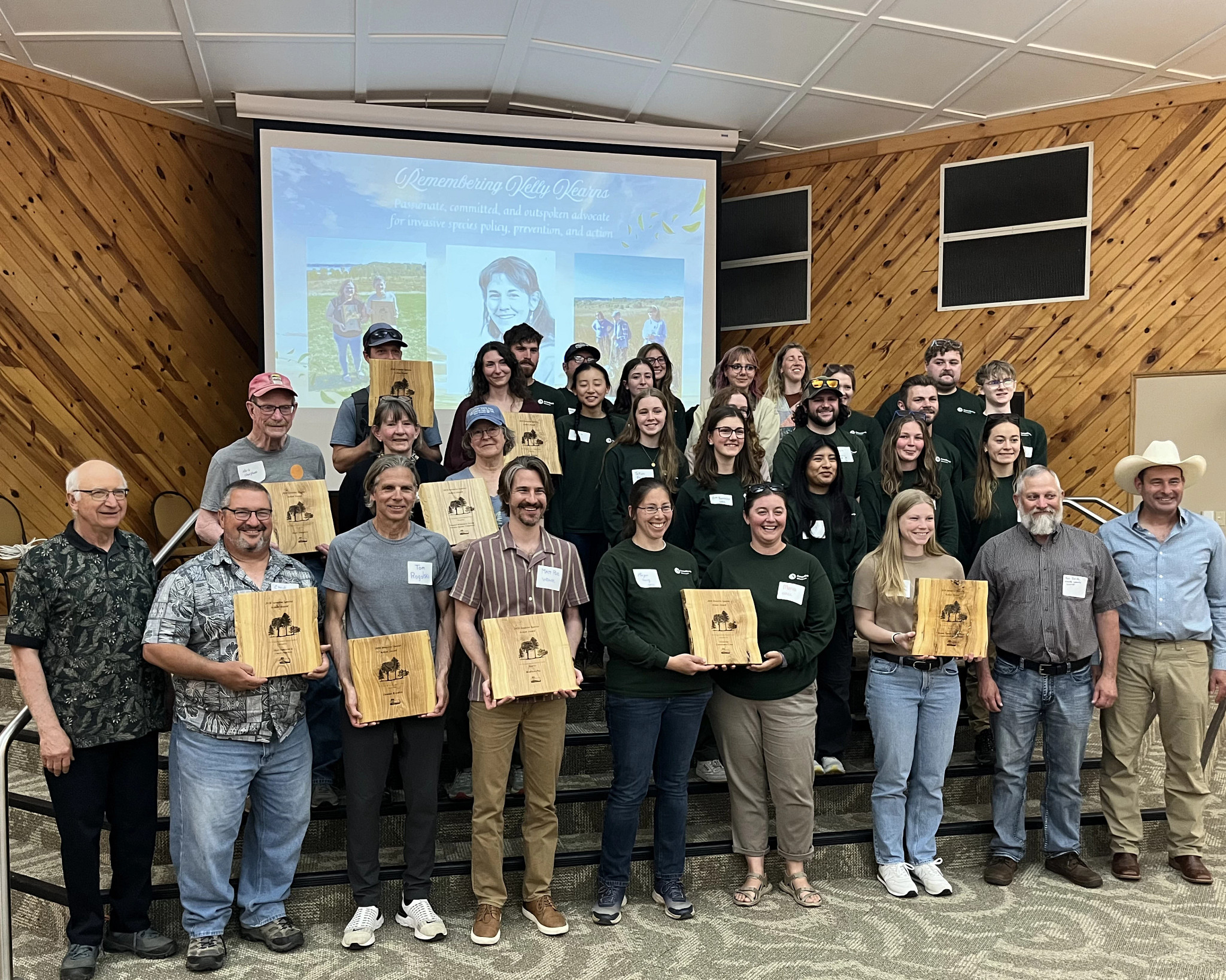 ISAM winners stand with their plaques. 
