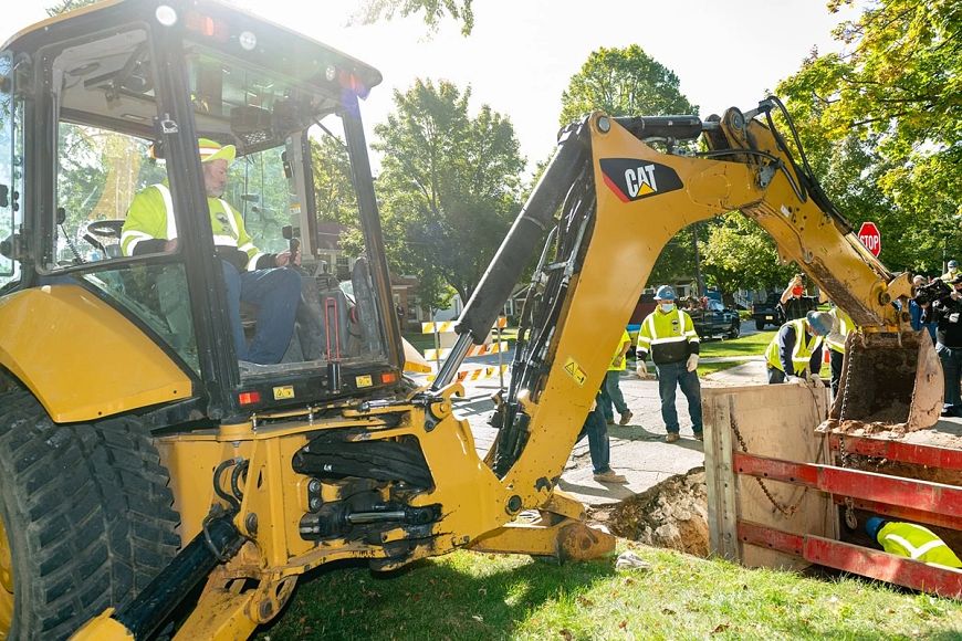 backhoe digging to remove a lead service line