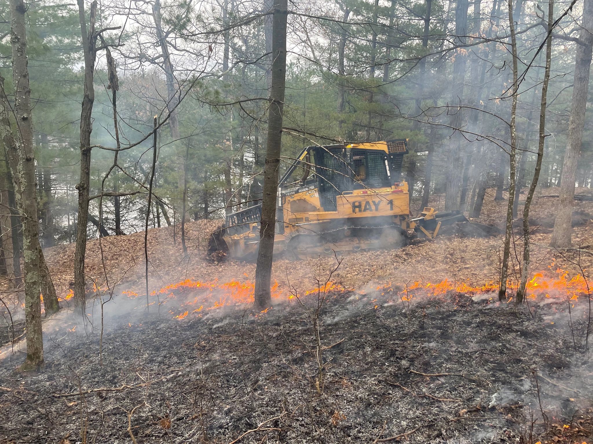 An image of a dozer help to suppress a wildland fire. 