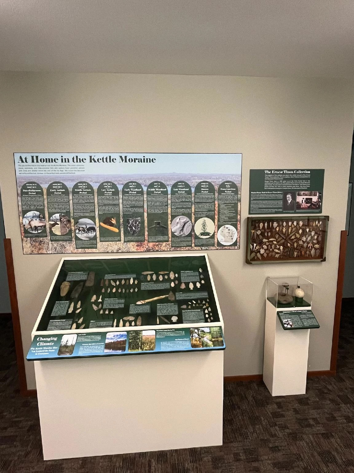 Arrowheads are displayed under an interpretive sign that describes the history of indigenous people in the area.