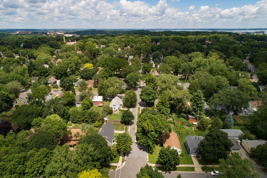 a drone photo of a Madison, Wisconsin, neighborhood with houses and lots of green trees