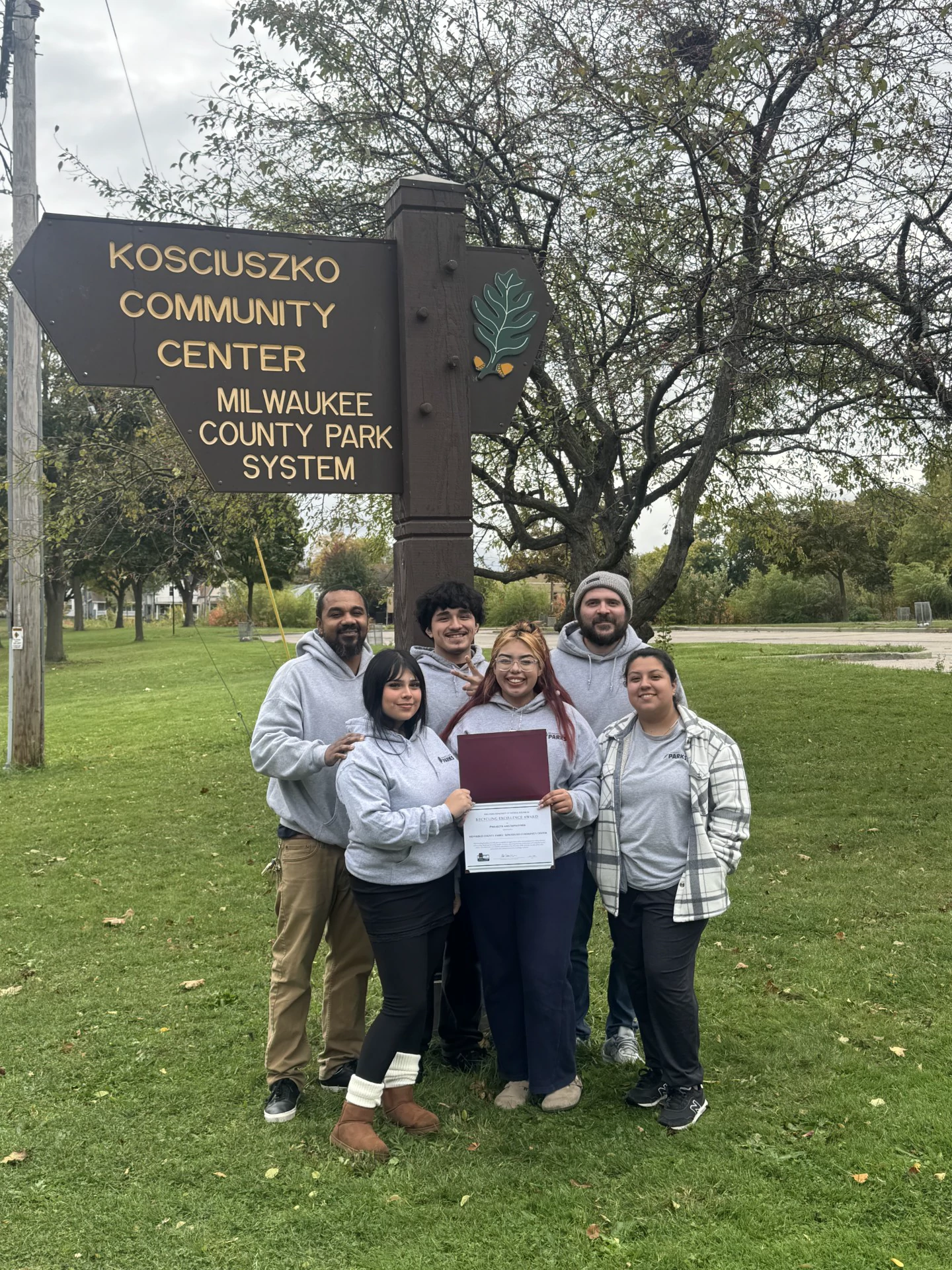 Employees from Milwaukee County Parks Kozy Center posing with Recycling Excellence Award