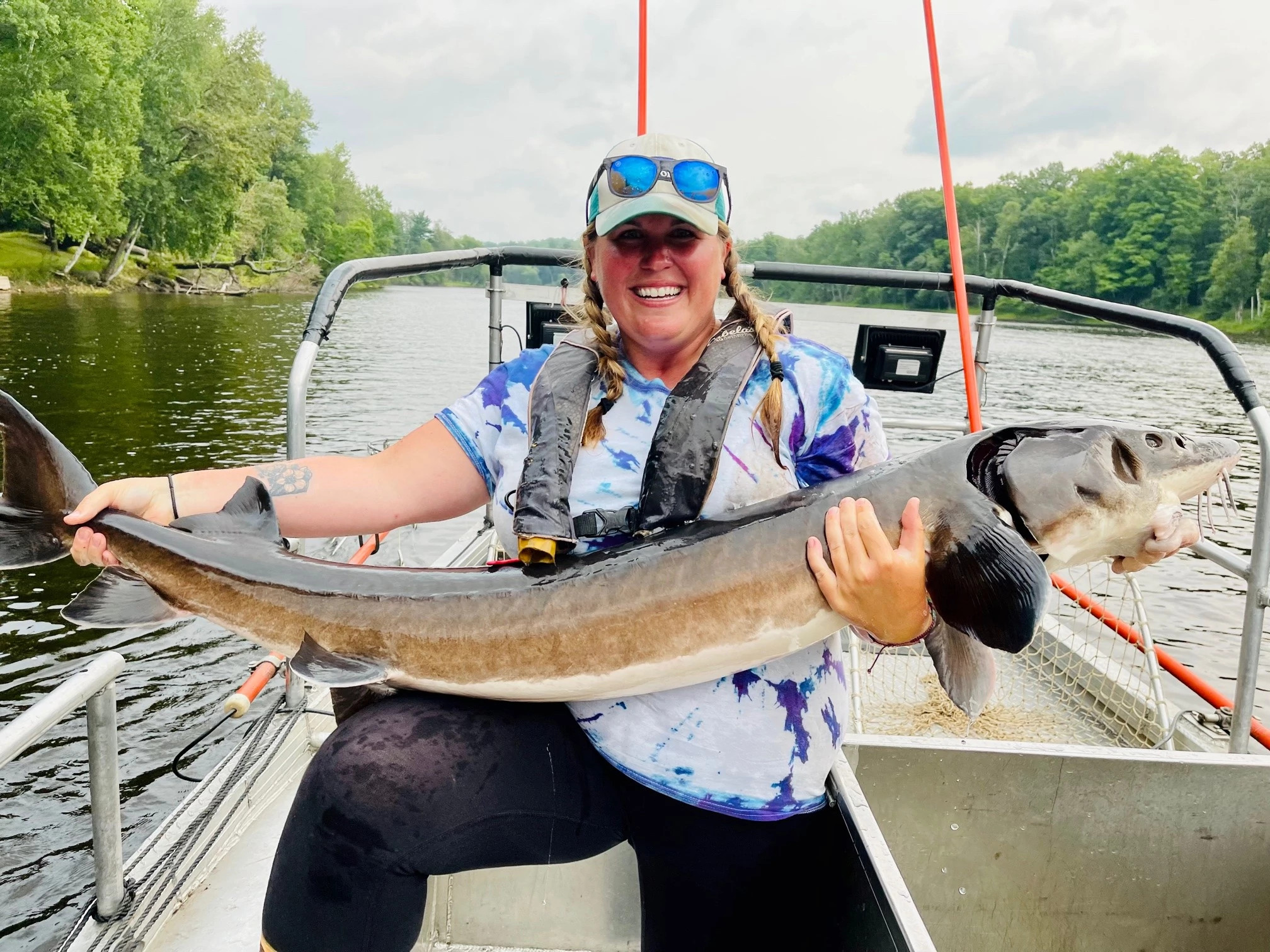 DNR Fisheries Technician Katie Renschen with a lake sturgeon captured during a 2021 electrofishing survey on the Menominee River