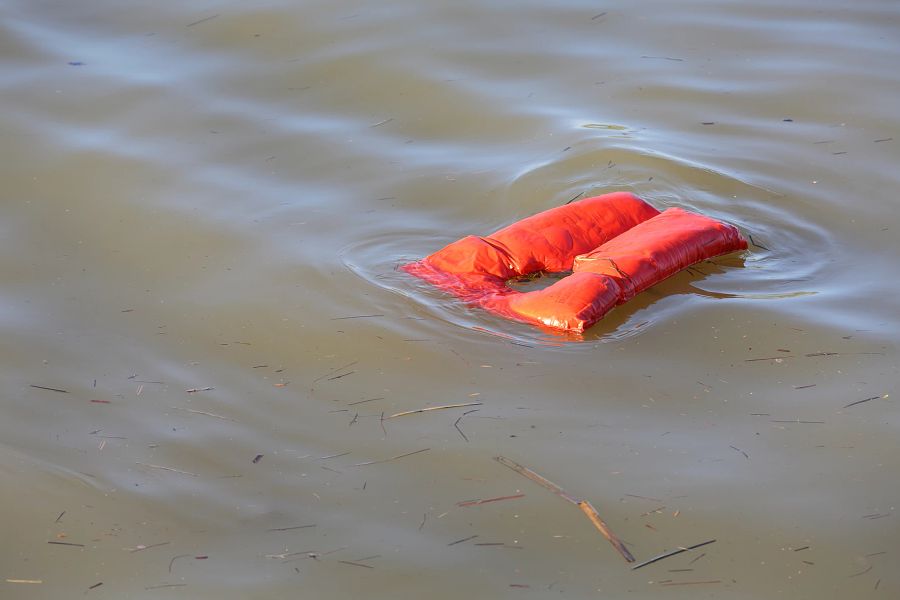 An overboard lifejacket drifting on the water