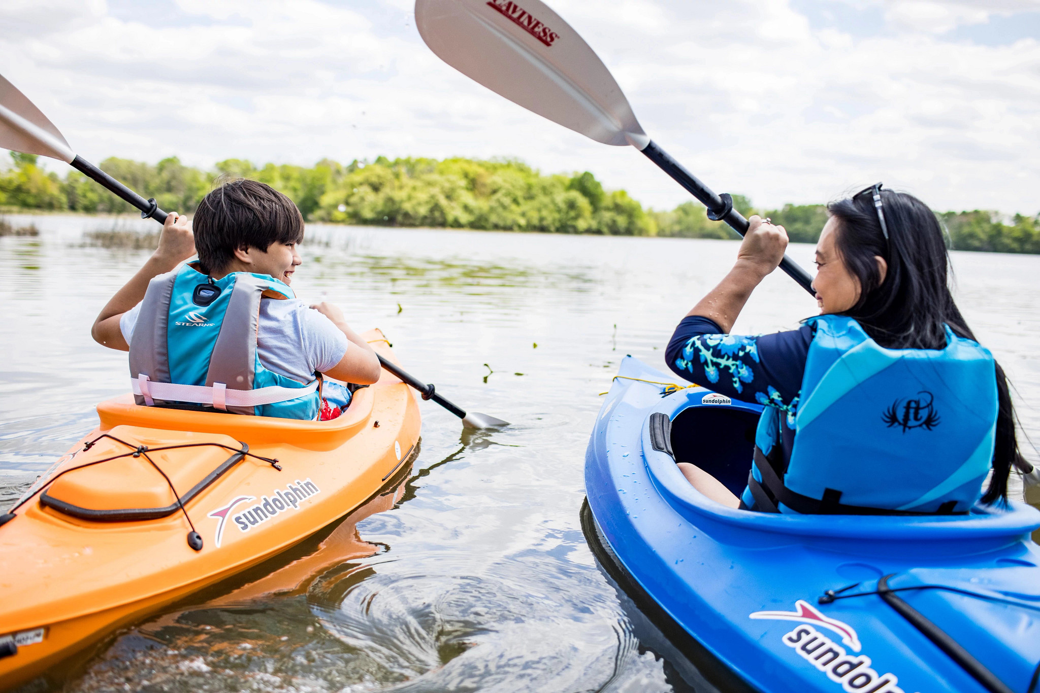 a mother and son enjoy kayaking on a lake in Janesville
