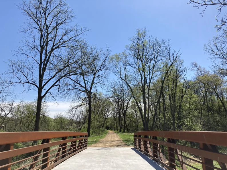 image of a gravel trail from a bridge in early spring